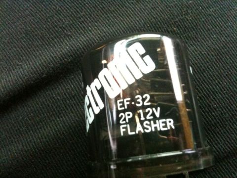 1995 Ford Bronco - Close-up of an electronic flasher unit with visible text and markings.