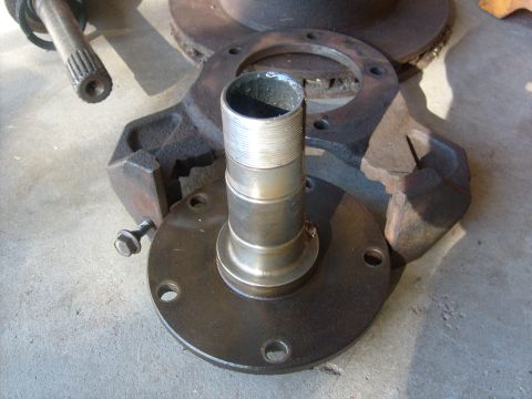 1994 Ford Bronco - Disassembled wheel hub assembly components laid out on a concrete surface.