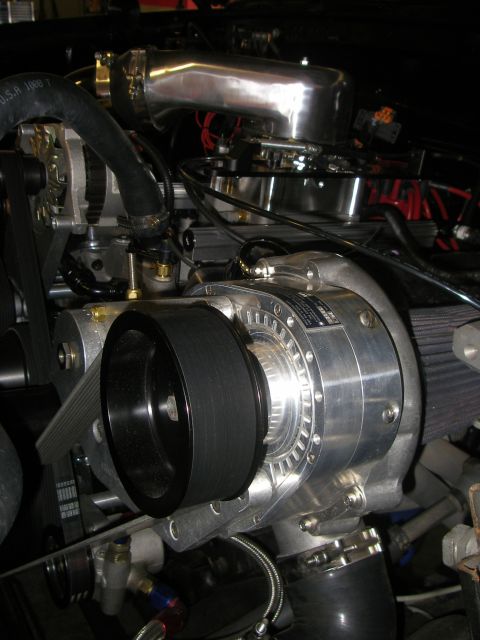 1990 Ford Bronco - Close-up view of a vehicle's engine, highlighting a polished supercharger and intake system.