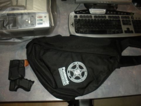 1996 Ford Bronco - A handgun rests beside a black bag "Panasonic TOUGHBOOK" and a law enforcement emblem.
