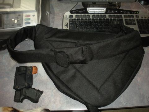 1996 Ford Bronco - A black bag and a handgun holster are visible on a desk next to a computer keyboard.