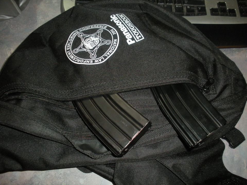 Black backpack with two rifle magazines and a National Law Enforcement Exploring Conference logo