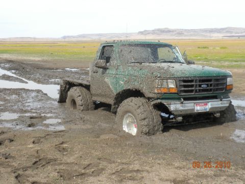 1989 Ford Bronco - This truck is covered in mud after getting stuck in a muddy field.