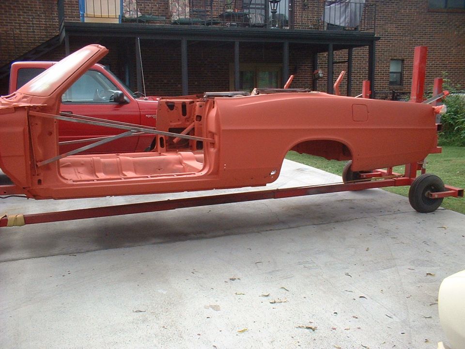 Orange 1967 Ford Galaxie convertible body on a trailer, side view