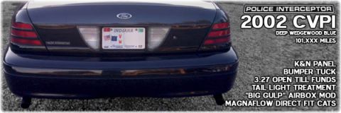 2002 Ford Crown Victoria - Rear view of a 2002 Ford Crown Victoria Police Interceptor in Deep Wedgewood Blue, showing custom modifications and mileage.