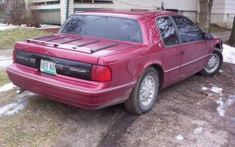 2006 Ford E350 - Maroon Mercury Cougar XR7 parked on a dirt lot in winter.