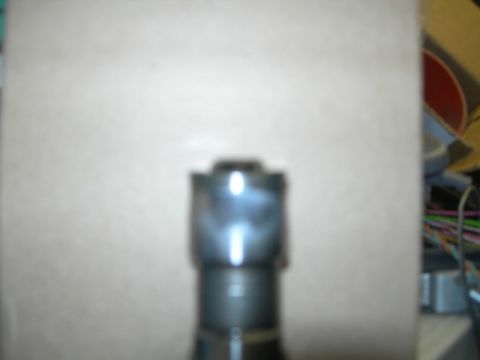 1984 Ford Bronco - Close-up view of a diesel injector part, likely for an engine rebuild.