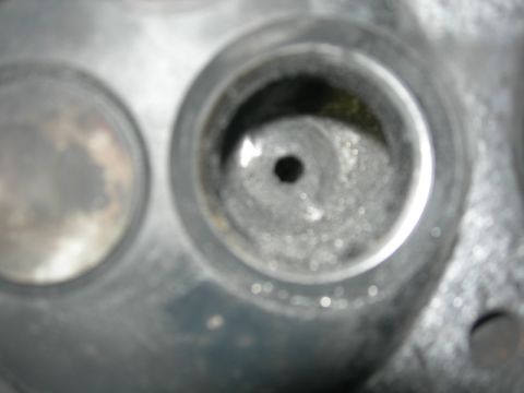 1984 Ford Bronco - This image shows a close-up of an engine's cylinder head, focusing on the valve openings and combustion chamber area.