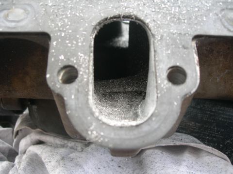 1984 Ford Bronco - This is a close-up view of an engine intake port, showing metal shavings accumulated within the opening.