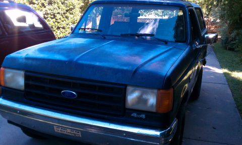 1987 Ford Bronco - This 1987 Ford Bronco 4x4 is seen from the front 3/4 angle on a paved driveway.