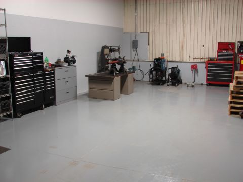 1993 Jeep YJ - A workshop scene displays various tools and equipment, including tool chests and a drill press.
