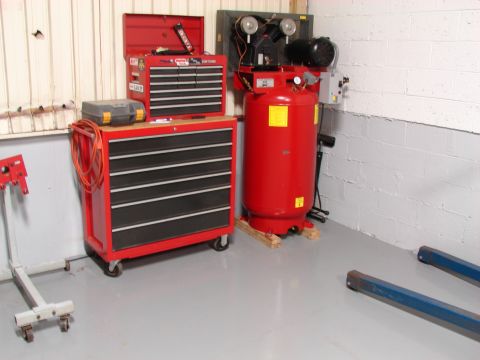 1993 Jeep YJ - A red rolling tool chest and a large red air compressor are set up in a garage space.