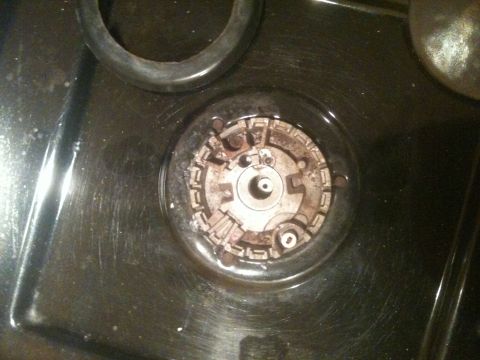 1989 Ford Bronco - A close-up view of a stove burner assembly, showing wear and tear.
