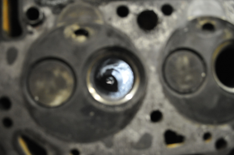 Close-up of a cylinder head showing two valves and combustion chambers