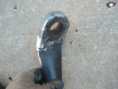 1984 Ford Bronco - Close-up of a welded metal component, likely a vehicle part, held by a gloved hand.