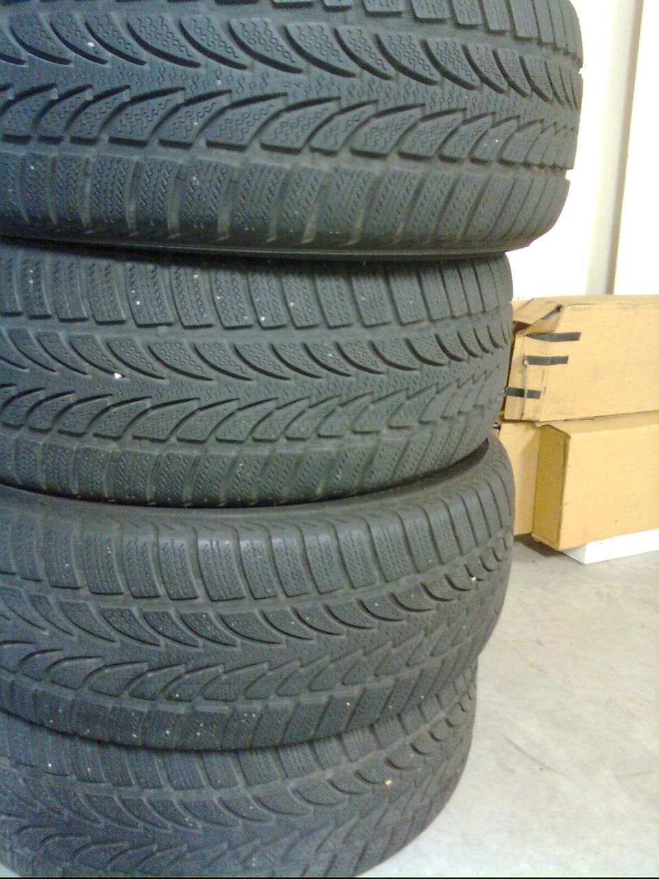 stack of four tires with winter tread pattern