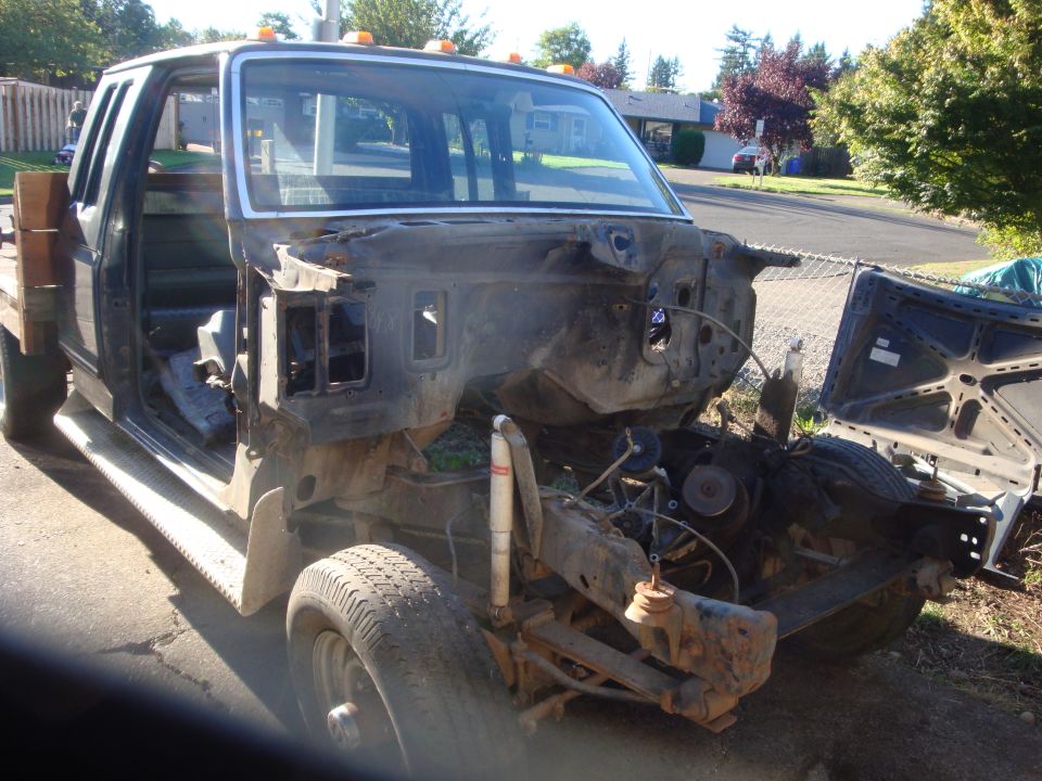 1989 Ford F-250 front end disassembled, showing engine bay and suspension components