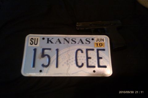 2000 Mercury Grand Marquis - A Kansas license plate and a handgun are displayed against a dark background.