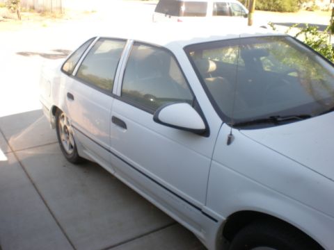 1990 Ford Taurus - This 1990 Ford Taurus is parked on a concrete driveway, showing its front passenger side.