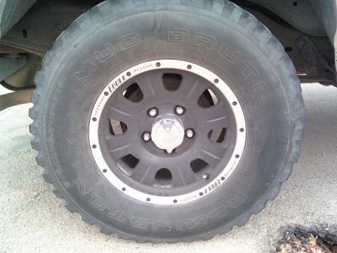 1987 Ford Bronco - Rear wheel with center caps.