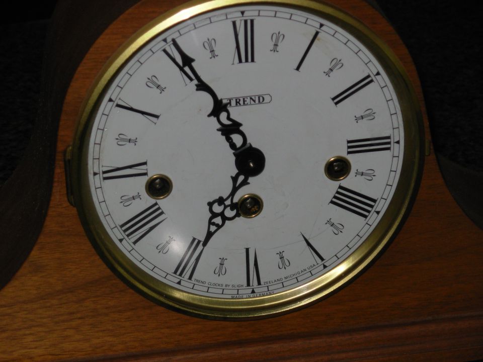 Trend by Sligh mantel clock dial with Roman numerals and brass bezel