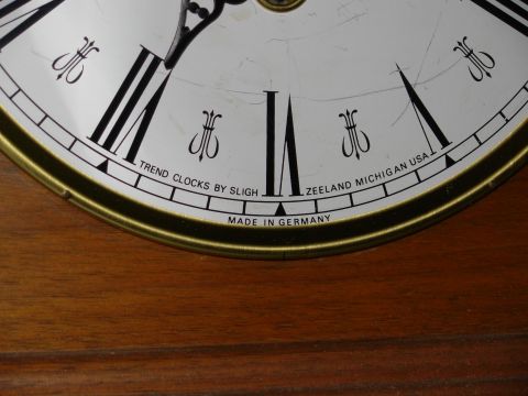 2004 Land Rover Land Rover - A close-up view of a clock face shows Roman numerals and text indicating it was made in Germany by Trend Clocks by Sligh.