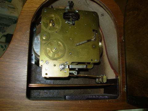 2004 Land Rover Land Rover - Close-up view of a clock's internal mechanism, showing intricate brass gears and the escapement assembly.