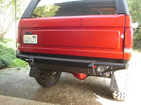 1989 Ford Bronco - Rear view of a red SUV with a custom bumper and tow hooks, showing a Washington license plate.