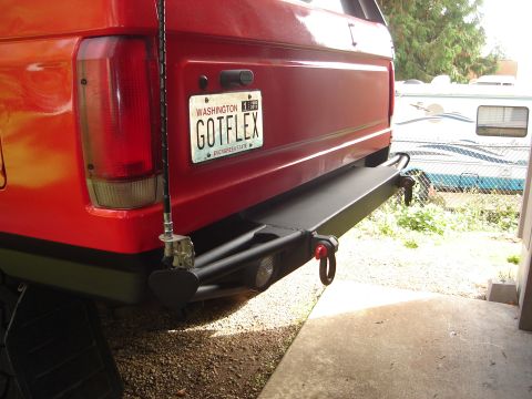 1989 Ford Bronco - Rear view of a red SUV, an aftermarket bumper with tow hooks and a Washington license plate.