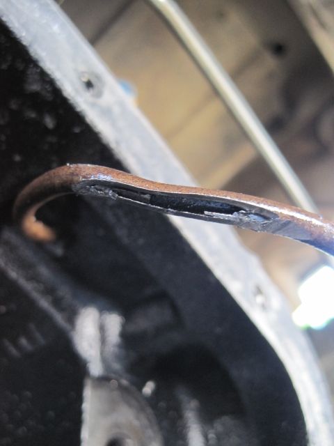 1989 Ford Bronco - A bent oil dipstick is shown inside the engine block, indicating a potential issue with the oil level or the dipstick itself.