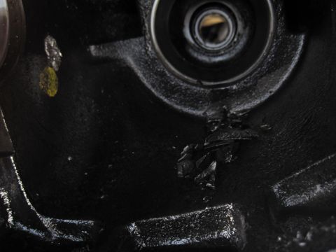 1989 Ford Bronco - Close-up of a damaged differential housing, showing a bearing race and broken metal pieces.