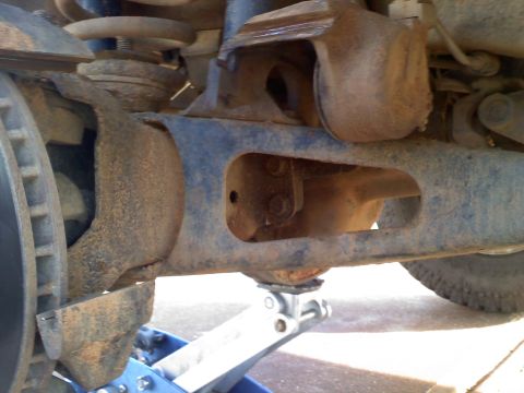1990 Ford Bronco - Vehicle suspension components, likely from a truck or SUV, are shown on a jack.