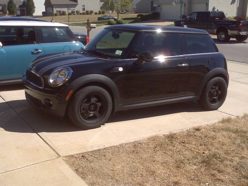 Black MINI Cooper hardtop with black wheels in driveway