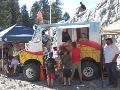 1989 Ford Bronco - An ice cream truck with a distinctive waffle cone design is seen at an outdoor event.