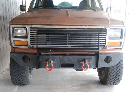 1982 Ford Bronco - Front view of a 1982 Ford Bronco, an aftermarket bumper and tow hooks.