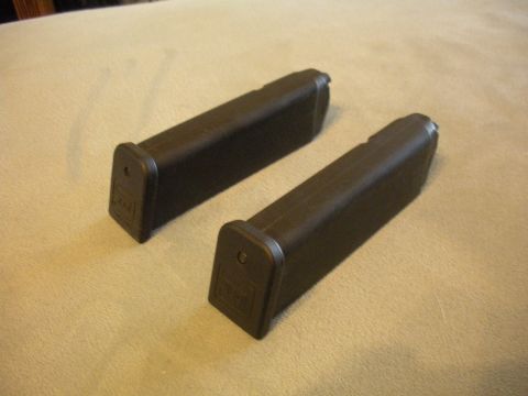 1996 Ford Bronco - Two black gun magazines are shown resting on a textured surface.