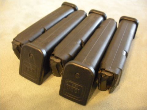 1996 Ford Bronco - Several Glock magazines are laid out on a textured surface.