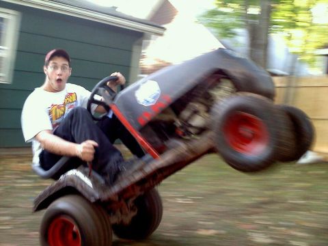 1989 Ford Bronco - Riding lawn mower doing a wheelie with a person at the controls.