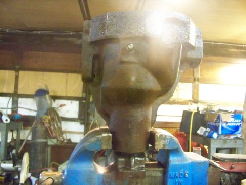 1989 Ford Bronco - A metal object is secured in a vise within a workshop setting.