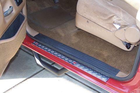 1990 Ford Bronco - The interior door sill of a 1990 Ford Bronco features diamond plate trim and tan carpeting.