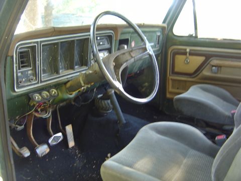 1986 Ford Bronco - Interior of a vintage truck, showing the dashboard, steering wheel, and seats. The vehicle appears to be from the 1970s.