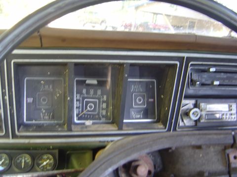 1986 Ford Bronco - Close-up of the instrument cluster and dashboard of an older vehicle, showing various gauges and controls.