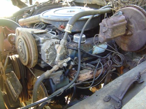 1986 Ford Bronco - Close-up view of an engine compartment, showing various mechanical components and wiring.
