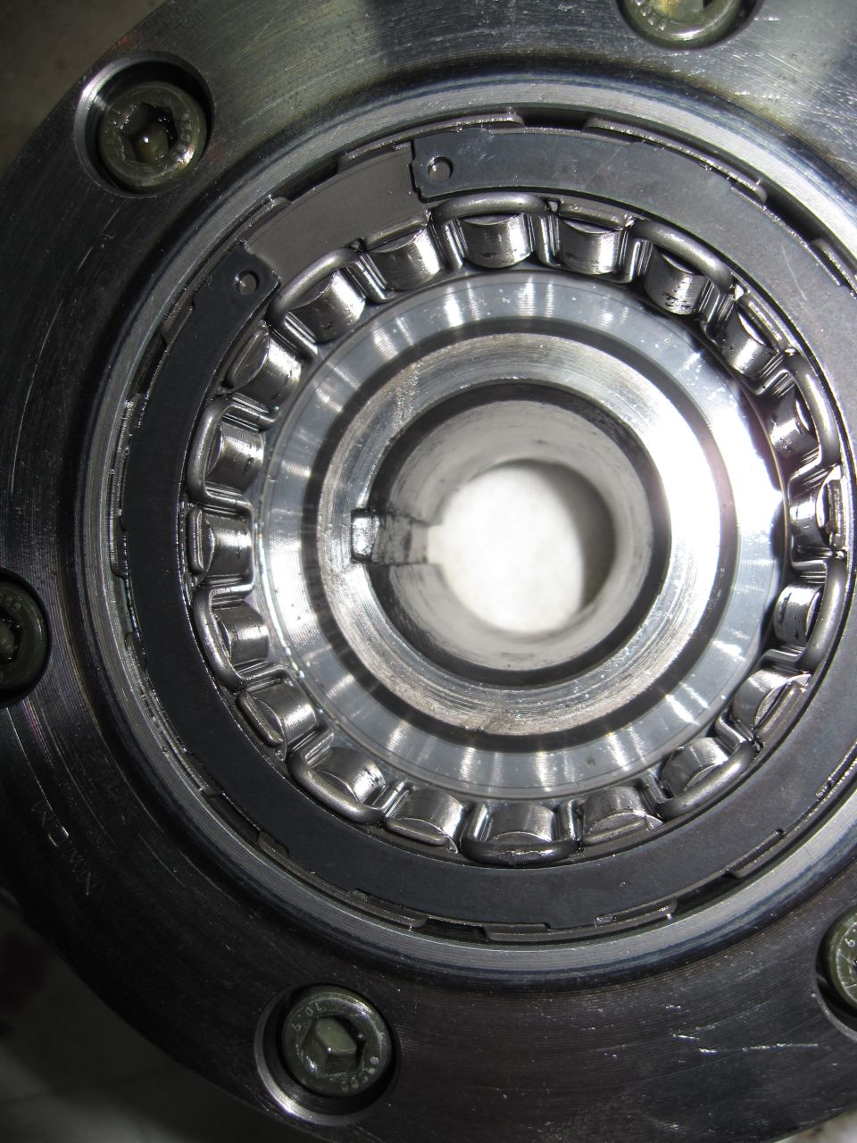 Close-up of caged roller bearing and splined shaft inside a disassembled gearbox case