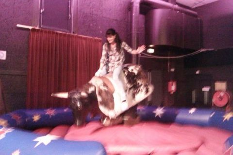 1991 Ford Crown Victoria - A person enjoys a ride on a mechanical bull at an event.