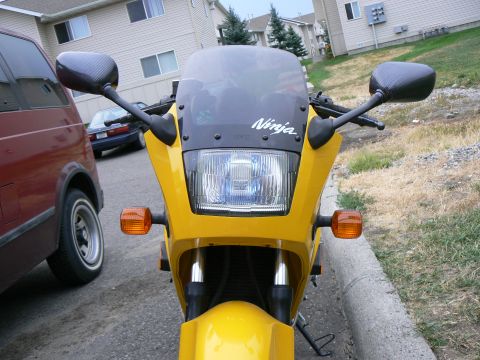 2002 Kawasaki Ninja - Front view of a yellow motorcycle with a Ninja logo visible on the windscreen.