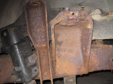 1979 Ford Bronco - Close-up view of heavily corroded vehicle suspension components, showing significant rust damage.
