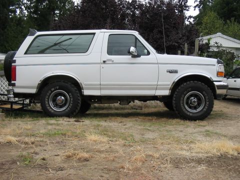 1995 Ford Bronco - This 1995 Ford Bronco is shown from the side, highlighting its new tires and overall condition.