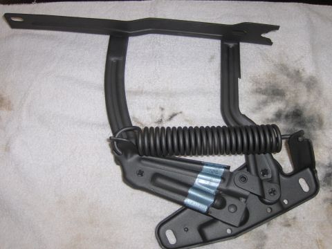 1970 Chevrolet Camaro - Black hood hinge with spring, likely for a 1970 Chevrolet Camaro.