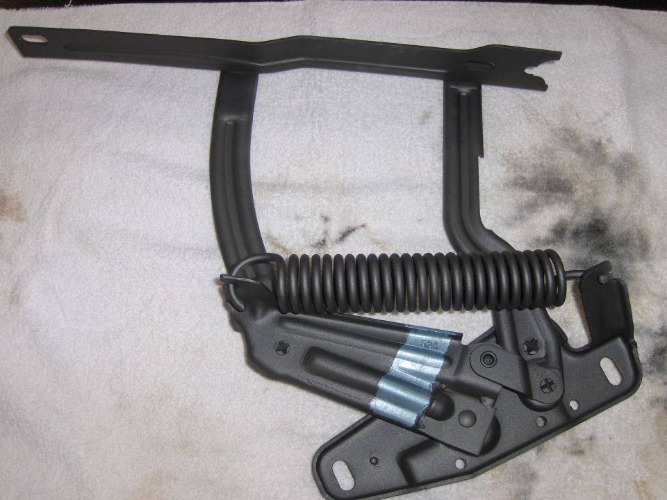 Black hood hinge with spring, part of a 1970 Chevrolet Camaro